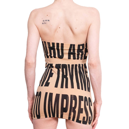 Beige strapless dress with black text on a white background